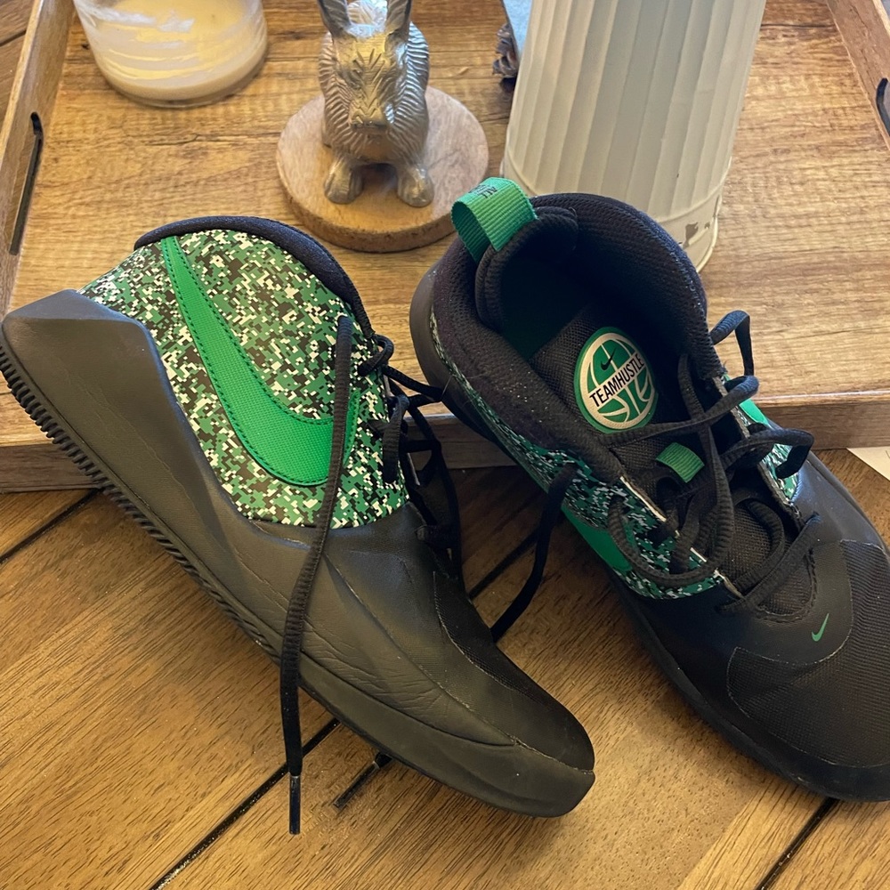 Nike mid-rise basketball shoes, black with green swoosh.  Worn on court only